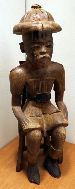 Sculpture of the Makonde people, Tanzania, depicting a seated colonial policeman.  Artist unknown; 2