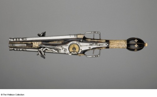 A unique double barrel wheel-lock pistol decorated with gold, copper, and antler.  Originates f