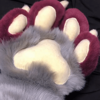 grey cuffs with red paws and pale paw pads. the person wearing shows off finger flexability