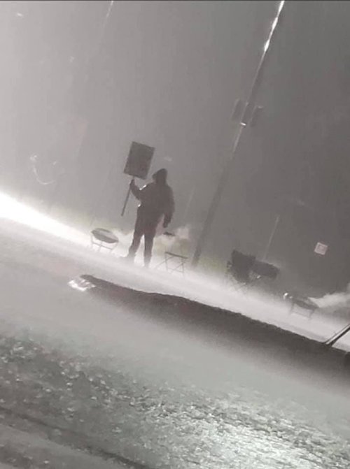 durnesque-esque:A lone Kellogg’s worker, Jason Schultz, holding the line during a heavy downpour out