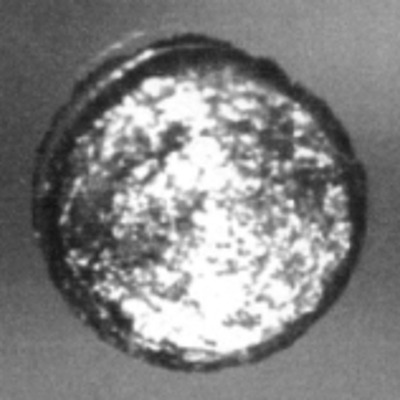 A 1 mm disc of californium next to the crystal structure of its most stable form at ambient conditio
