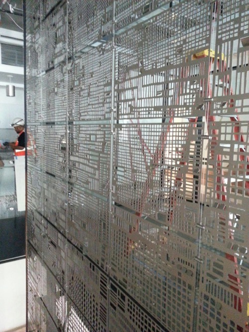 Peek at Floating Data installation at big tech company HQ in San Francisco. 60 anodized aluminum panels, 25 feet tall.