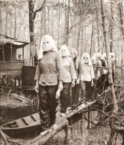  Vietcong women, wearing masks, returning