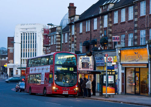 The 83 bus picks up passengers on Vivian Way, London Borough of Barnet.  The Virgin Active fitness c