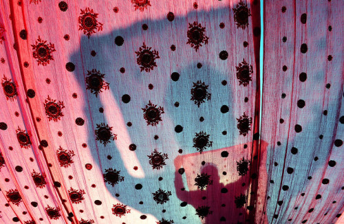A Pakistani worker dries fabric that was dyed at a factory in Lahore on March 6, 2013.[Credit : Arif