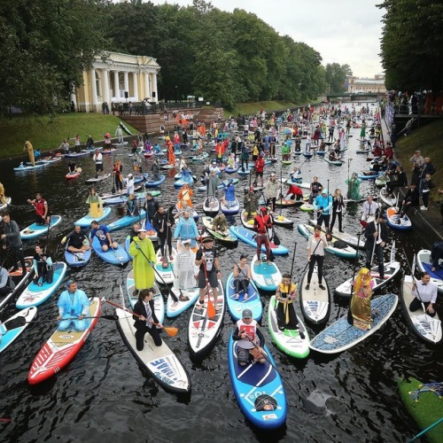 Costumed stand up paddle boarders surf at the Fontanka-SUP surfing festival in the Moika and the Fon