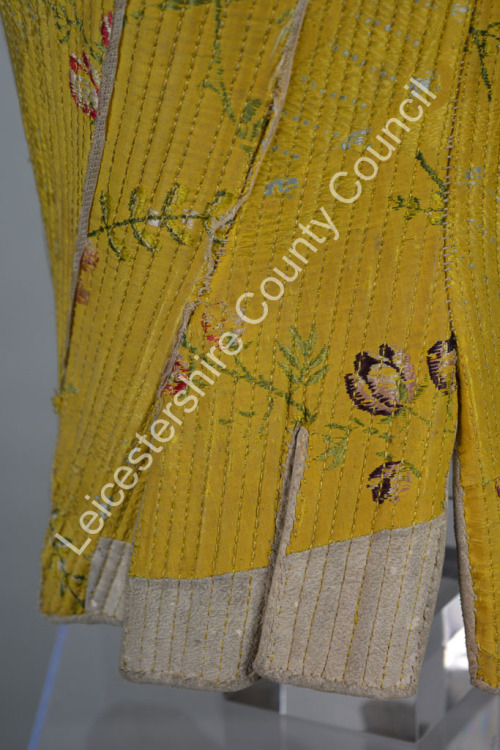 symingtoncorsets: Corset made from yellow silk brocade and trimmed with white leather. It dates from