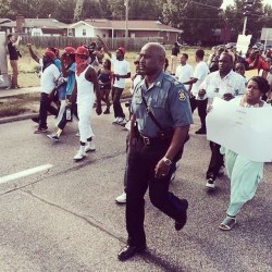 randomlilworld:  Highway Patrol Officer Ron Johnson lead protestors on a march through #Ferguson  ✊✊✊✊ 