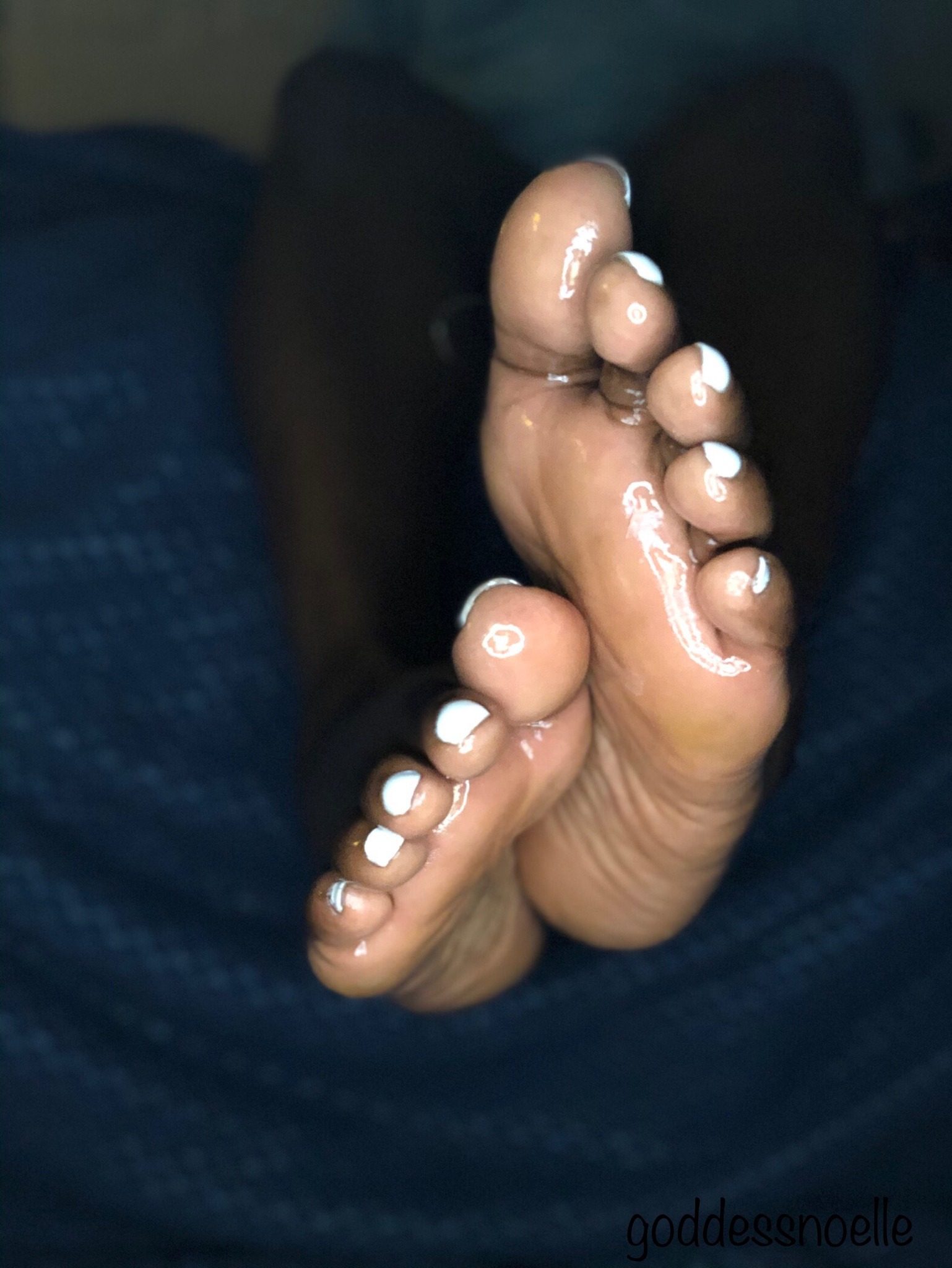 Ebony feet on face