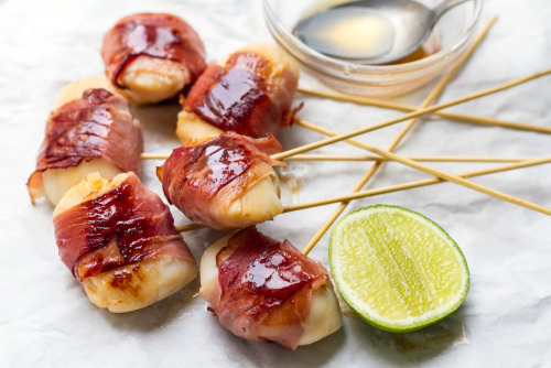 Scallop Lollipops  These juicy scallops are wrapped in prosciutto and brushed over with lime and map