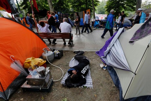 Istanbul June 12, 20131. A pretzels vendor maneuvers his cart in front of a large group of riot poli