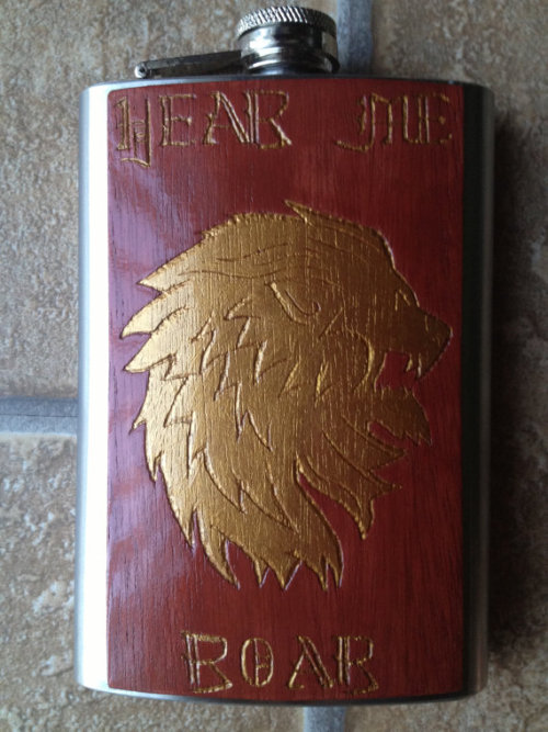 thedrunkenmoogle:  Game of Thrones Carved Flasksby SineCera Represent your favorite house! Steve Barnett has carved the house sigils and words of House Baratheon, Stark, and Lannister onto wood affixed to flasks so that all may know your allegiance. Also