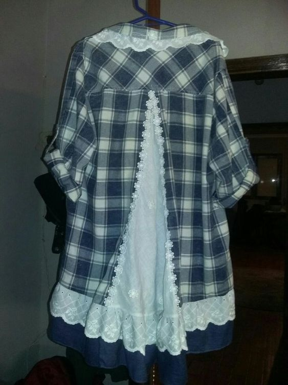 A plaid shirt with a white lace godet in the back.