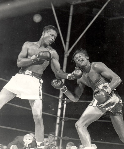 Sugar Ray Robinson lands an uppercut on Kid Gavilan (1948)