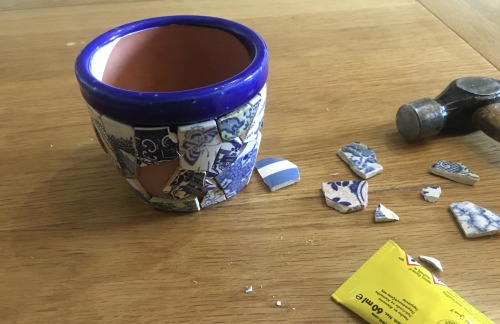 Constructing a pot from shards of crockery found while beachcombing on the Thames.