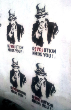 217lemurs:  &ldquo;Revolution/Love needs you!&rdquo; - hidden behind a black BMW (could that be irony)