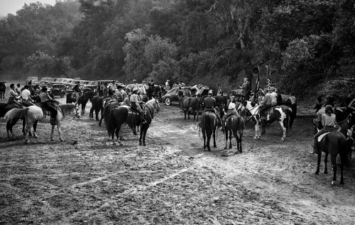 Members of the San Fernando Horse Owners Assn. listen to a sermon delivered from an ox cart by Rev. 