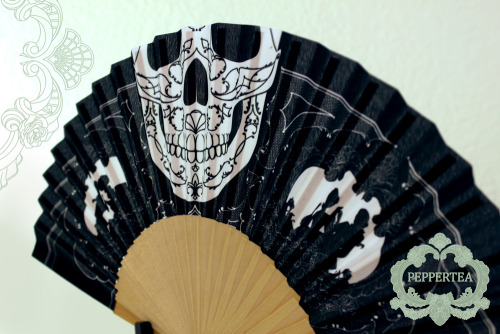 A folding fan. If you peek over the top, it looks like the skull is the lower part of your face. I d