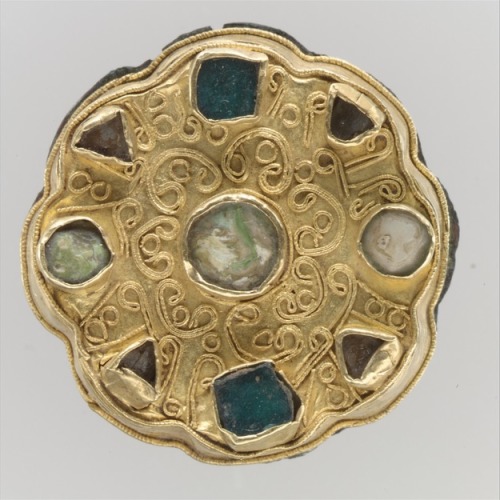 Disk BroochFrankish650- 700Gold with green and clear glass, mother-of-pearl, and copper “The d