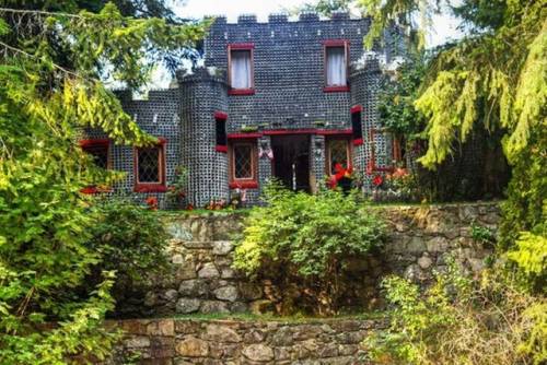 magicalandsomeweirdhometours: This castle-like house is built entirely of empty embalming fluid bott