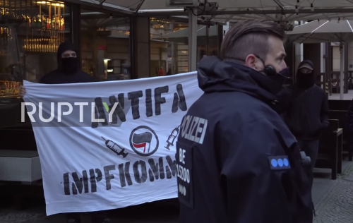 Hundreds of anti-lockdown protesters hold a “silent march” in Berlin, on 21 Dec. 2020.The neolib org