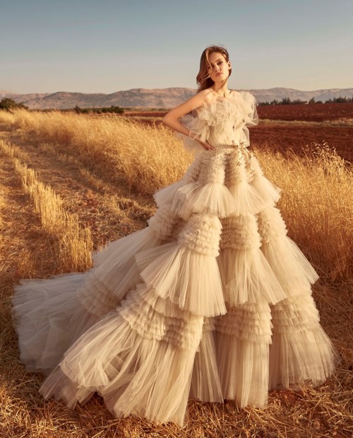 This dreamy Zuhair Murad princess wedding dress features dramatic tiered ruffles all over cinched by