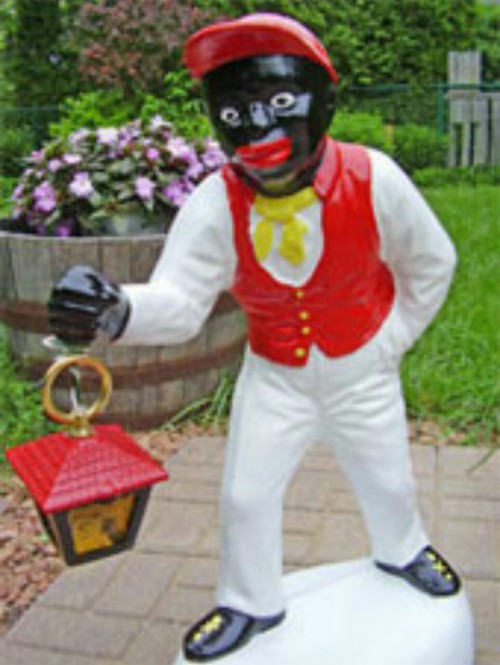 wakeupslaves:  The African-American lawn jockeys often had exaggerated features, such as big eyes with the whites painted in, large red lips, large, flat nose and curly hair. These pieces were typically painted in gaudy colors for the uniform, with the