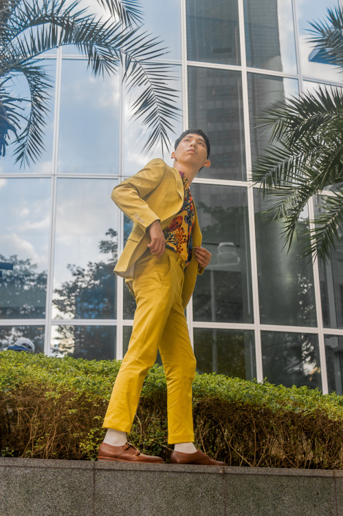 Men moving between tall buildings and light and shadow. Bright colors are one of the most refreshing