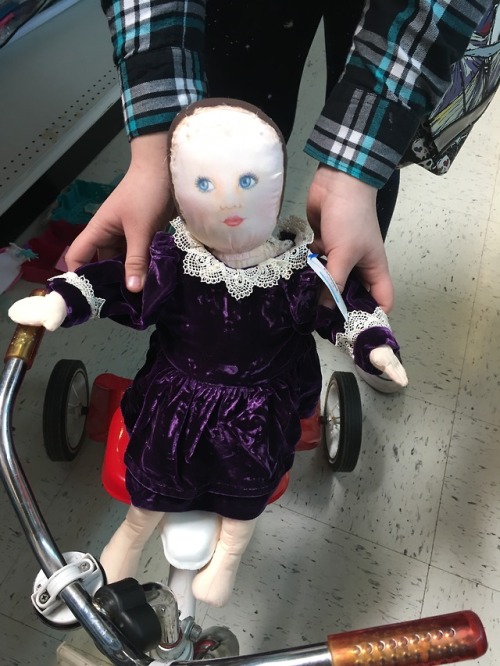 Beautiful baby ready for a tricycle ride.