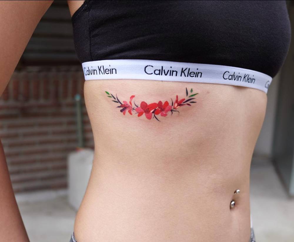 Subtle wildflower tattoo on the rib cage  Tattoogridnet