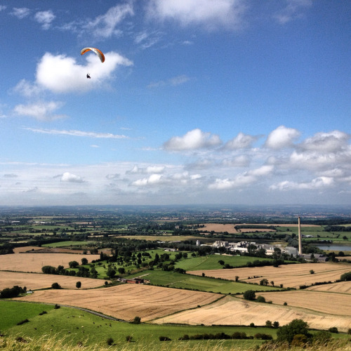 Madmen hanging from kites over the Westbury White Horse. Wiltshire, England.