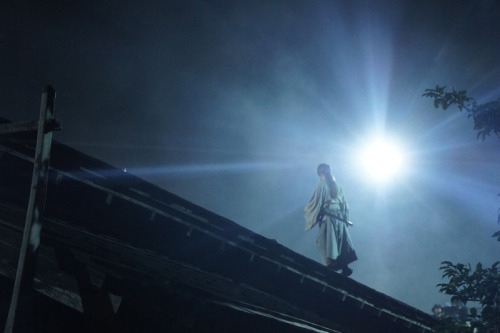 Kenshin way up on the roof.  From a still of a movie sequel for the live action adaptation of&n
