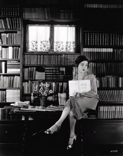 Alla Nazimova in her library holding a copy of Constanin Stanislavski&rsquo;s memoir, ‘My 
