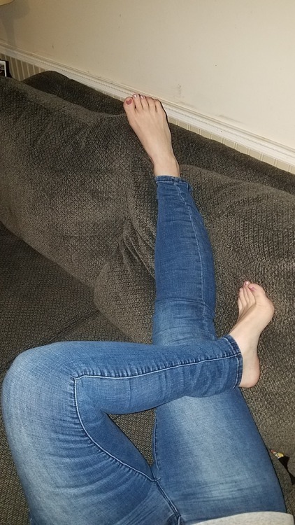 My pretty wifes beautiful bare feet in jeans relaxing on the couch.please comment