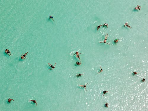 sunfornia:   fairhy:   Dead Sea, Israel Photograph by George Steinmetz, National GeographicSwimmers float effortlessly in the salt-laden waters of the Dead Sea near Ein Bokek, Israel. Ten times saltier than seawater, the lake is extremely buoyant and