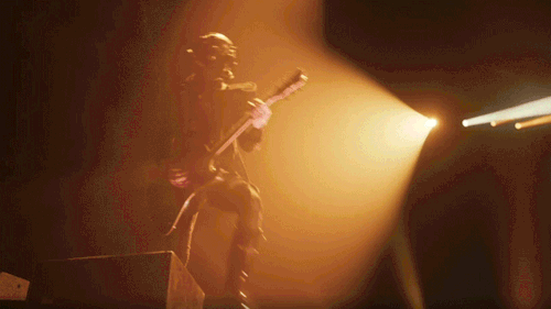 Phantom pulls away from where he was standing and walks down some steps as lights flash around.