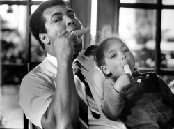 imransuleiman:  Muhammad Ali shares a popsicle with his daughter Hana Ali at home in Louisville, Kentucky in 1980.  
