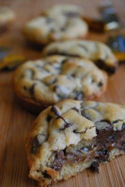 housewifesecrets:   foodishouldnoteat: Deep Dish Chocolate Chip Caramel Filled Cookies  We interrupt this porn for a cookie…  Oh glory be