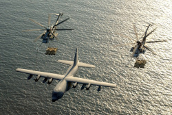 militaryarmament:  Two Marine CH-53E Helicopters each carrying two Humvees undergo aerial refueling from a KC-130. 