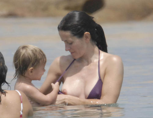 toplessbeachcelebs:  Courtney Cox (Actress) bikini nipple slip in Sardinia, Italy (June 2006)