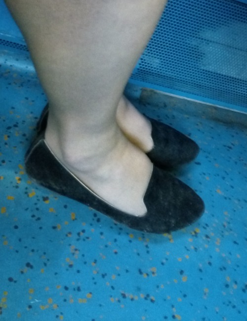 suede effect black flats on the train, barely black sheer tights.