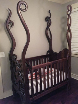 randomitemdrop:  cultofweird:  Eldritch crib hand-carved by Garrick Andrus  Item: crib armed with tentacles to protect the baby in its care