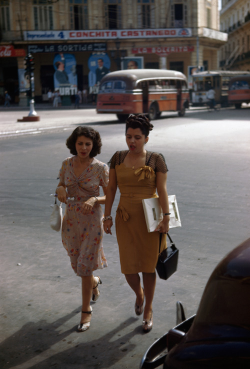 Two women on a shopping trip walk across a street in Havana, Cuba, 1947.Photograph by Melville B. Gr