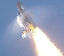 spaceexp:  Florida, USA: Atop gigantic pillars of fire NASA’s Space Shuttle Atlantis  — sporting Prandtl-Glauert condensation due to the Prandtl-Glauert Singularity and sprouting shock waves — majestically soars towards space on 8 September 2000.