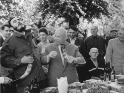 Khrushchev and Castro drinking from horns.