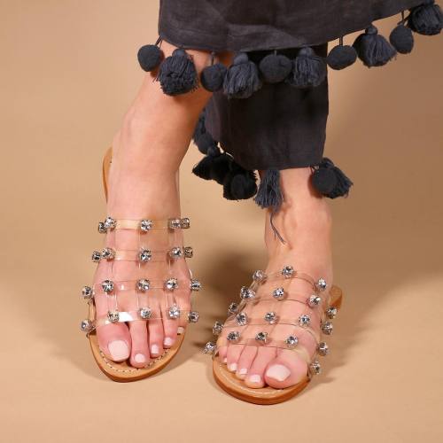 Unique banded sandals on pretty feet.
