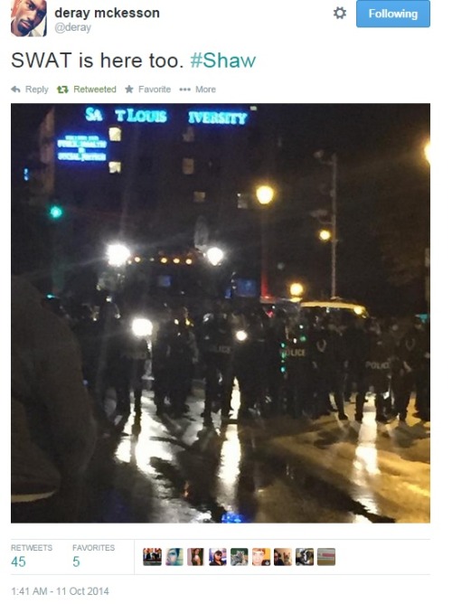 iwriteaboutfeminism:Police in riot gear follow peaceful protesters as they march down the sidewalk.E