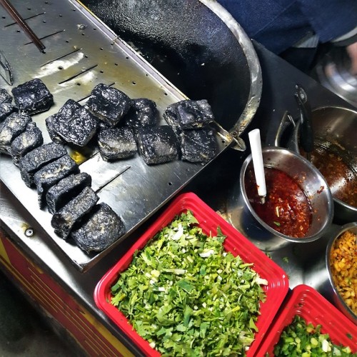 The famous Changsha stinky tofu - fermented until it turns black, then fried and served with tasty g