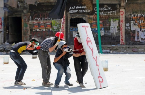 Police Enter Taksim Square in Istanbul1. Protesters take cover from a police water cannon during cla