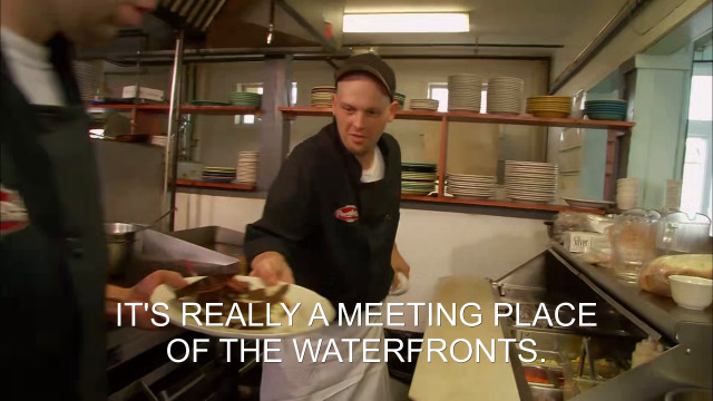 94% sure it's a person preparing food in a kitchen. Caption: IT'S REALLY A MEETING PLACE OF THE WATERFRONTS.